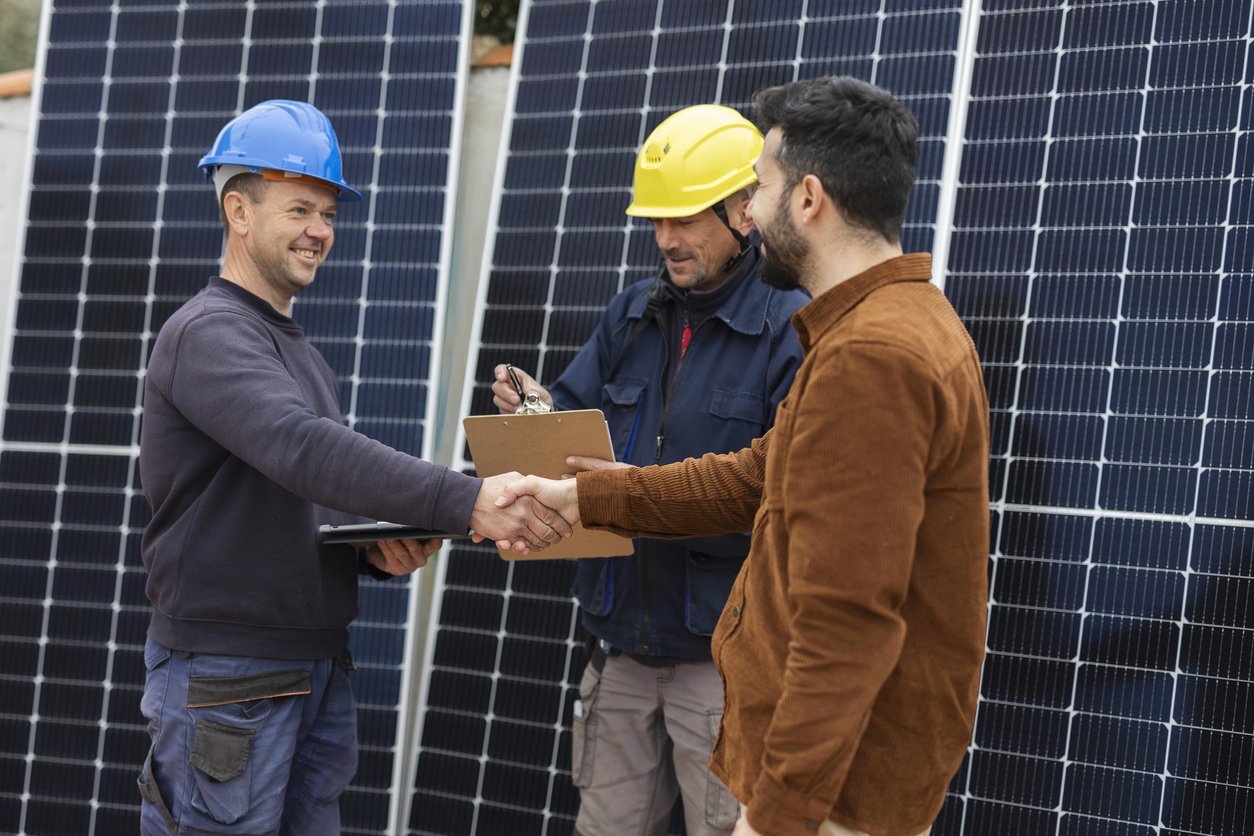 Pessoas apertando as mãos após fechar o orçamento de energia solar.